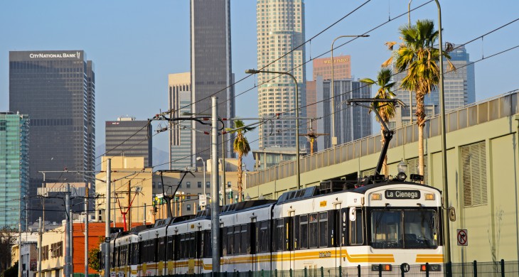 "Expo Line and L.A. skyline" by Steve and Julie, Test train southbound on Flower Street. Used under Creative Commons License: CC BY 2.0 DEED